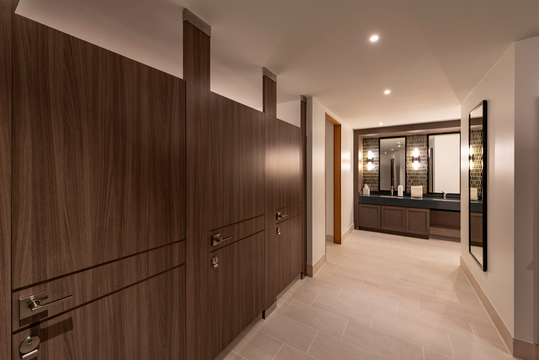 A view of an upscale bathroom with wooden partitions.