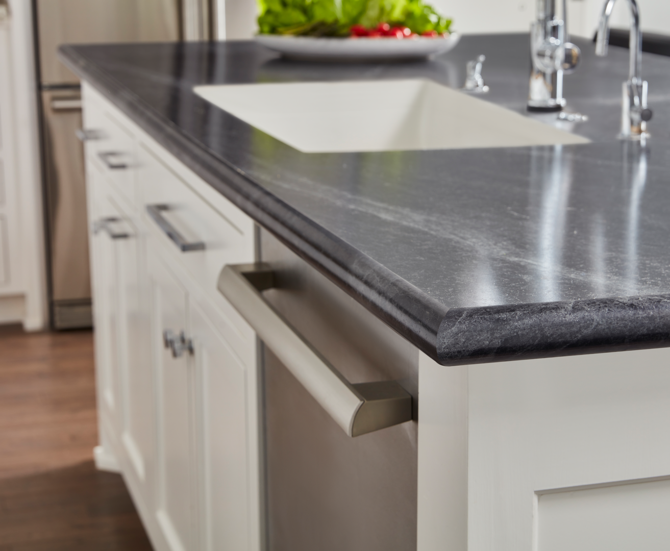 Black kitchen countertop and white cabinets