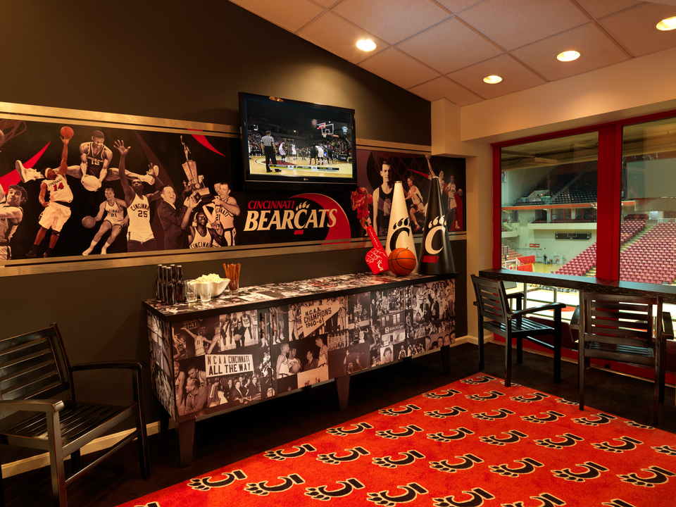 A basketball suite featuring the University of Cincinnati logo and basketball imagery throughout the suite.