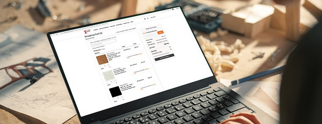A person searching on their laptop to buy laminate.