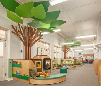 A children's library featuring a bright, woodland theme.